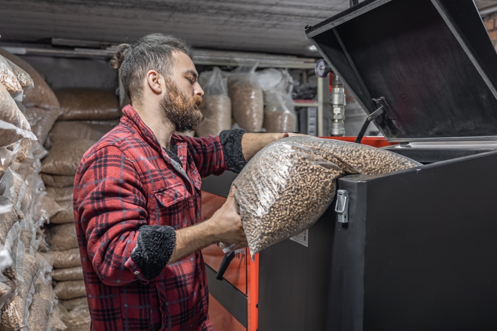 man loads pellets solid fuel boiler working with biofuels economical heating 169016 14811