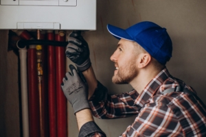 service man adjusting house heating system 1 scaled 1